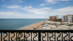 A beach view with a clear sky, a sandy shore, and buildings in the background. - Sonoran Sea (Puerto Peñasco)