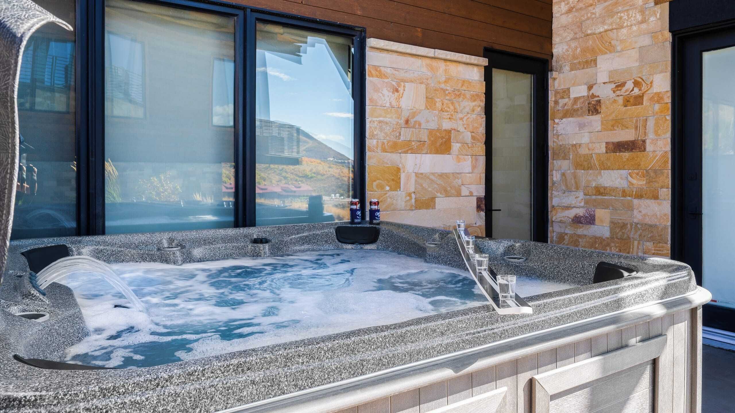 Un jacuzzi con revestimiento de piedra, una ventana y una puerta.