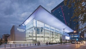 Un edificio moderno con fachada de vidrio y un llamativo letrero que dice 'WINTRUST ARENA'.