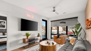 A modern living room with a sofa, coffee table, and TV.