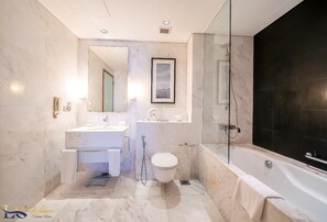 Bathroom features a bathtub and glass-enclosed shower area.
