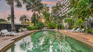 A swimming pool with lounge chairs and palm trees. - The Lookout at Northshore Tower- Waterfront Luxury with Panoramic Sea Views (Cairns North)