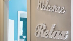 A wall with 'Welcome Relax' signs. - Roma Design San Giovanni Colosseo area (Rome)