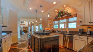A spacious kitchen with a central island, stainless steel appliances, and pendant lighting. - Spacious 6-Bedroom Mountain Home –Minutes from Park City’s Year-Round Adventures (Kamas)