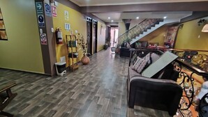 A spacious lobby with a wooden floor, a staircase, and a seating area. - Hotel Golden Killa (Huaraz)
