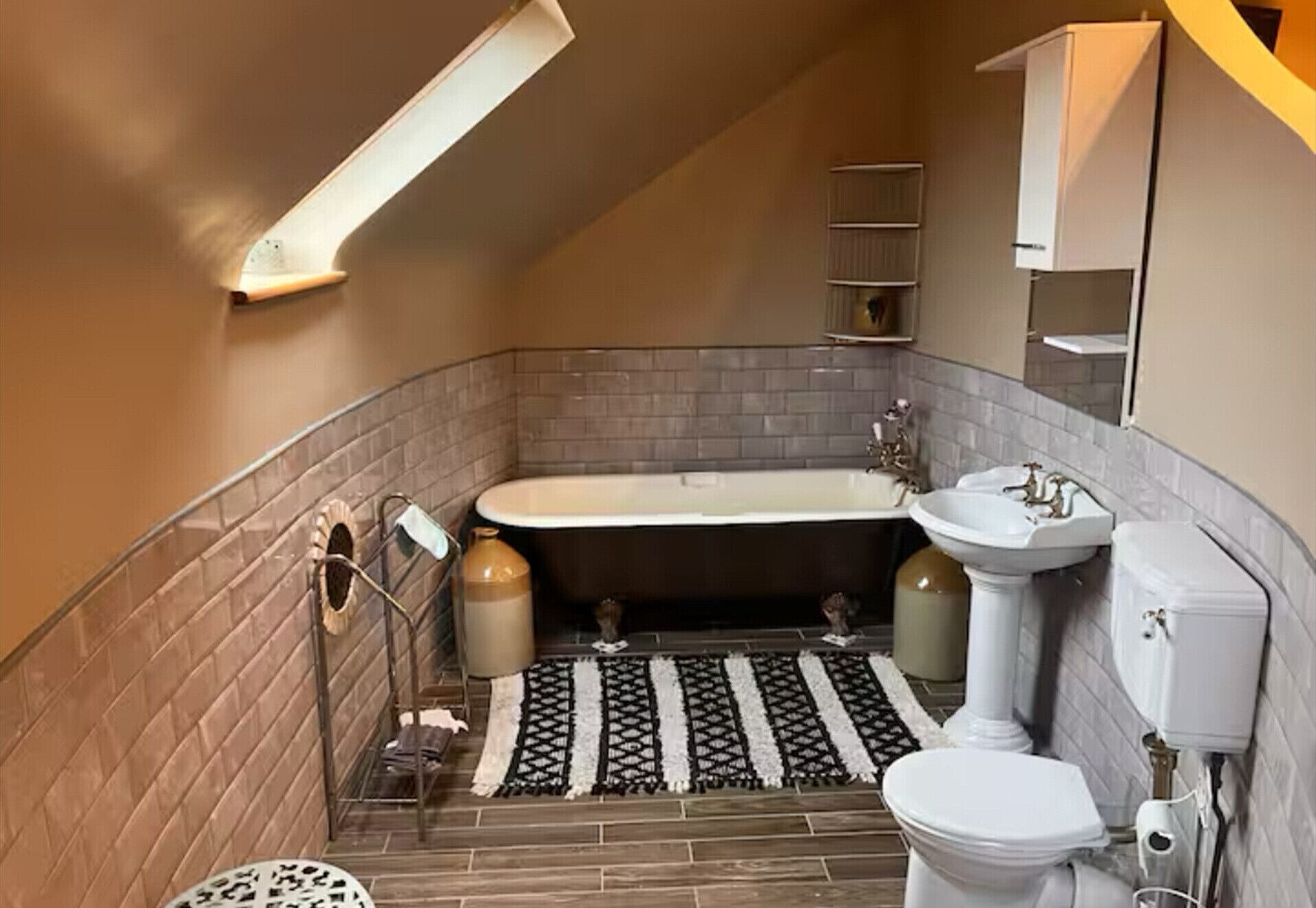 A compact bathroom with a bathtub, a sink, and a toilet.