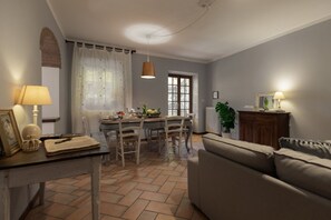 A dining area with a table, chairs, and a window.