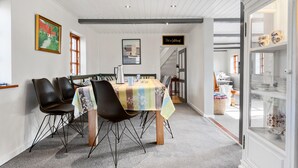 A dining area with a table set for four, surrounded by chairs, a coffee pot, and a pitcher on the table. - Nice home in Farsø with WiFi (Farsø)