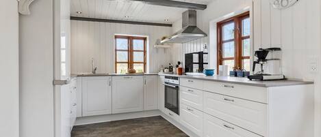 Fridge, stovetop, dishwasher, coffee/tea maker