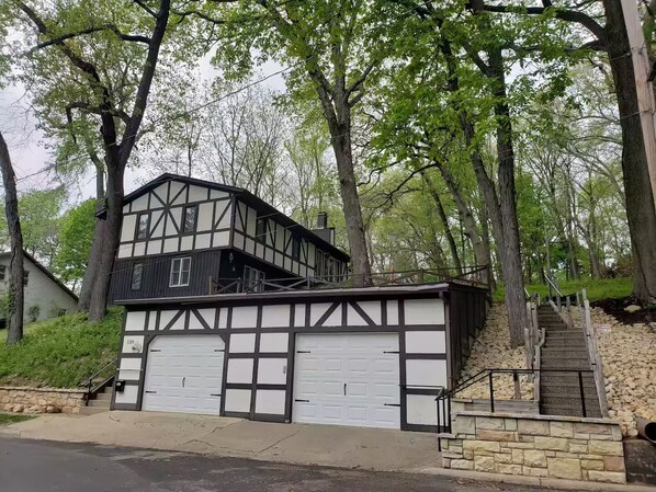 A Tudor-style house with a garage and a staircase leading to a second floor. - House On the Hill Charming 3-bedroom house with Rec Room, in lovely Savanna (Savanna,)