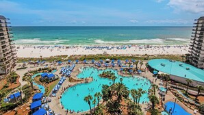 A resort with a large pool area, beach access, and multiple levels of accommodation.