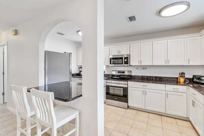 Fridge, microwave, oven, stovetop - Island Delight: Pool Spa Dog Friendly by Anna Maria Life Vacation Rentals (Holmes Beach)
