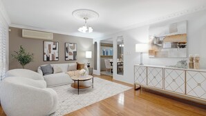 A living room with a sofa, coffee table, and artwork on the walls. - Holiday Inn (Parkinson)