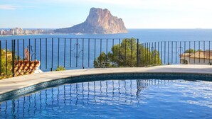 A pool with a view of a coastal city and a prominent rocky island. - Gasparet by Interhome (Calpe/Calp)
