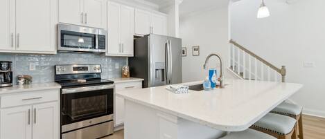 Coffee/tea maker, fridge, microwave, oven