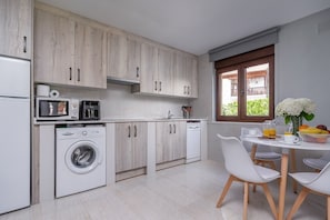Fridge, microwave, cookware/dishes/utensils, dining tables