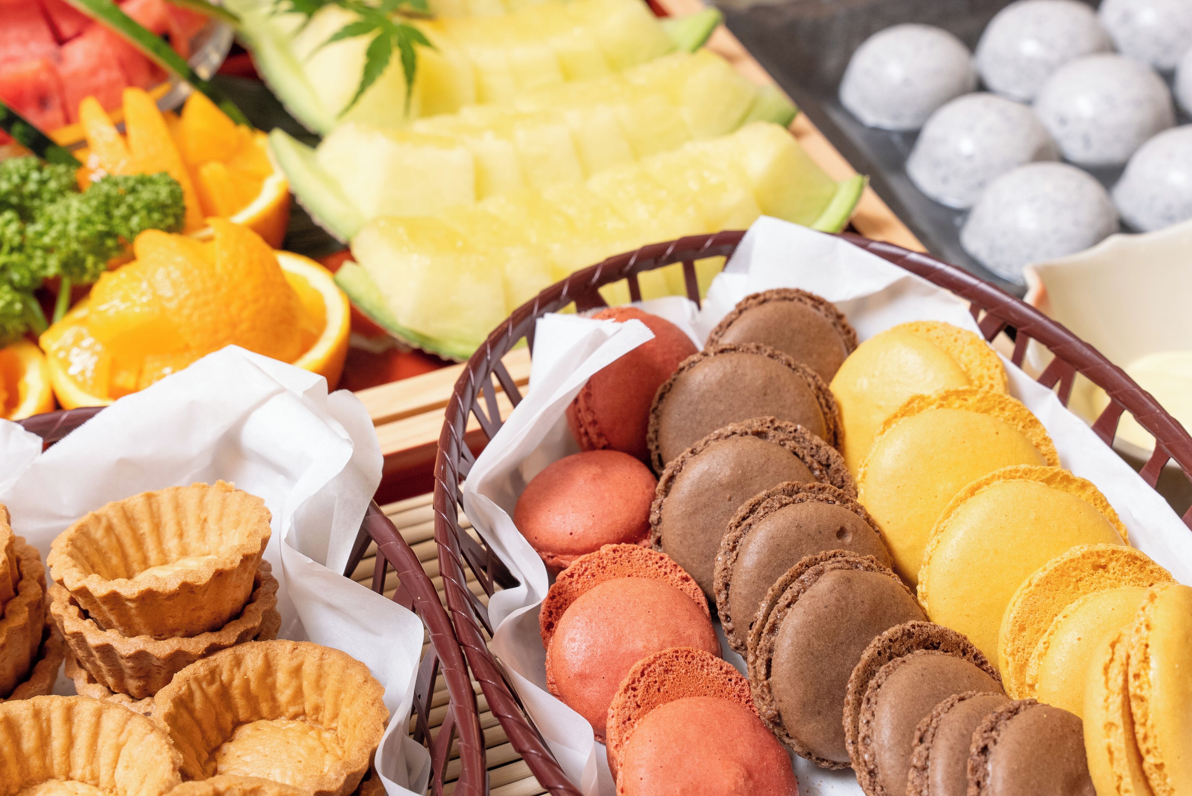 A variety of pastries and fruits arranged on a table.