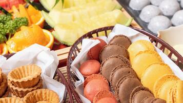 A variety of pastries and fruits arranged on a table.