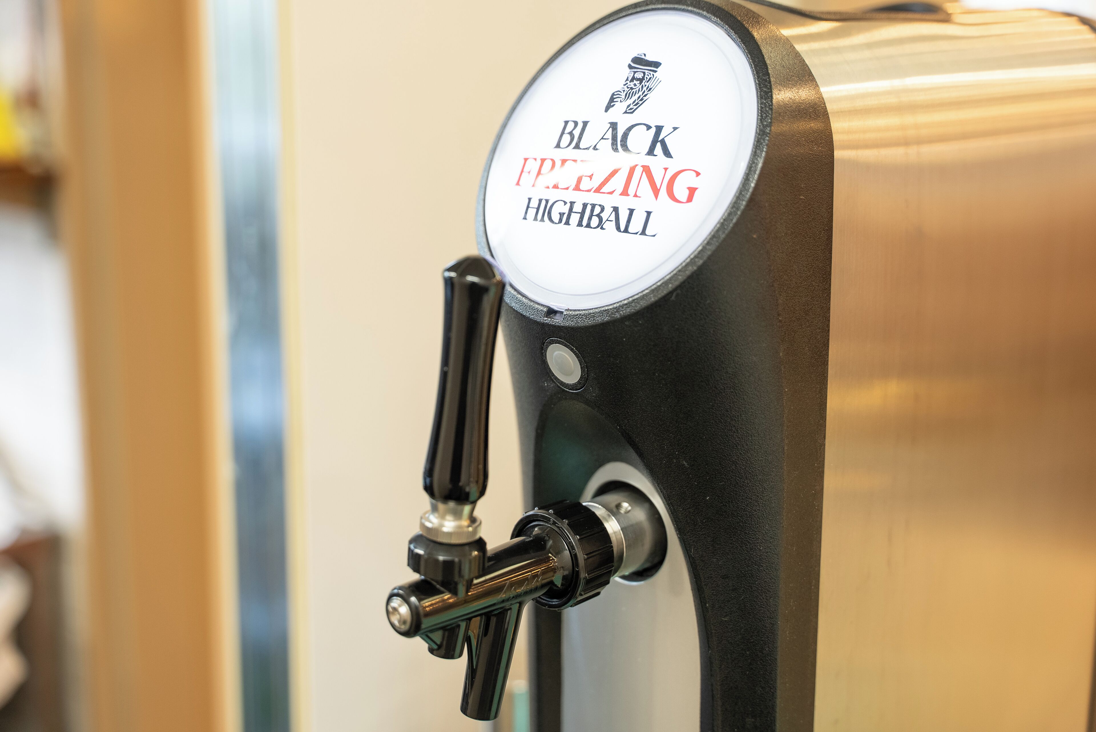 A beer tap labeled 'BLACK ICE LEADING HIGHBALL' on a metallic surface.