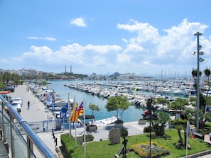 Stunning marina with boats docked in calm waters, adjacent to a scenic promenade.