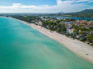 An aerial view of a coastal town with a beach, houses, and a mountain in the background. - Playa Blanca 100m Sandy Beach by Interhome (Alcúdia)