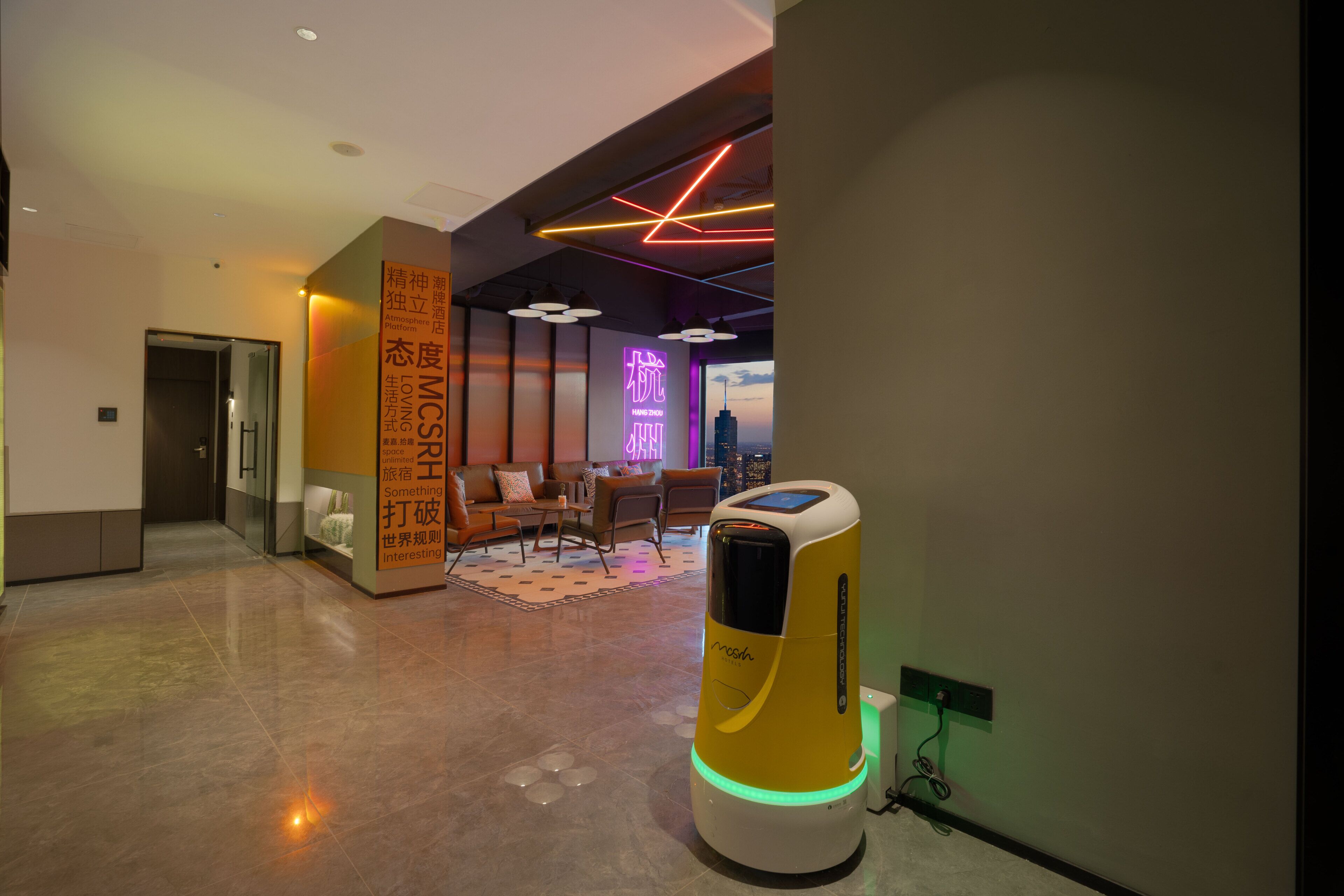 A modern hotel lobby with a massage chair, seating area, and a neon sign.