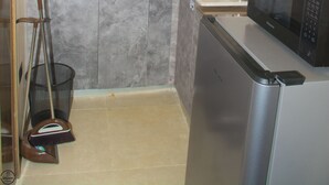A compact kitchen with a sink, a microwave, and a toaster. - 1BD Serenity Dubai Suites (Abuja)