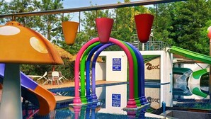 A swimming pool with colorful slides and a water play area. - TheRabbithome (Nakhon Nayok)