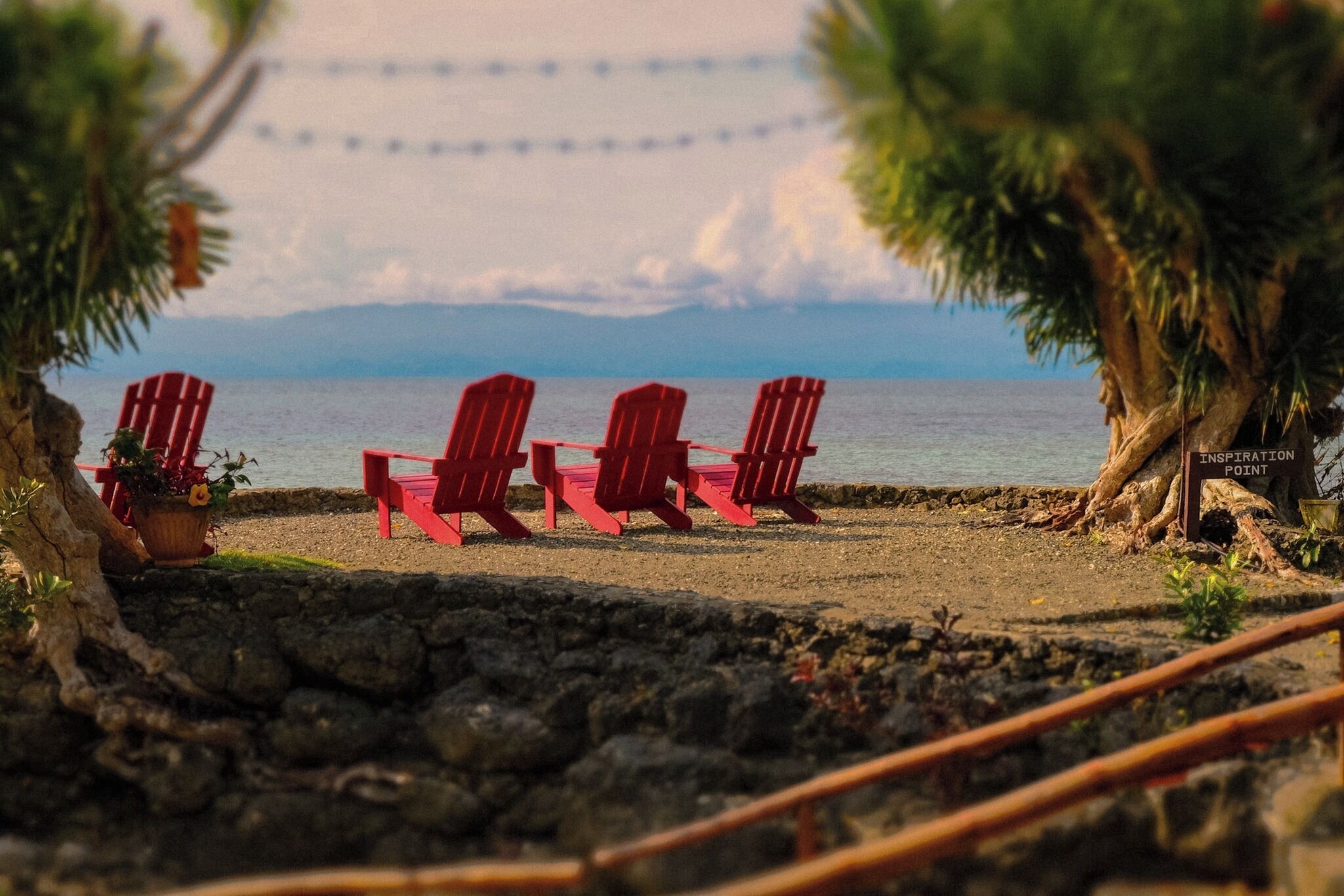 A beach with red chairs and a sign labeled "Inspiration Point".