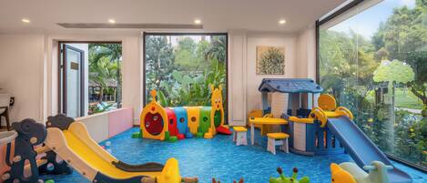 A children's play area with slides, a playhouse, and a pool.