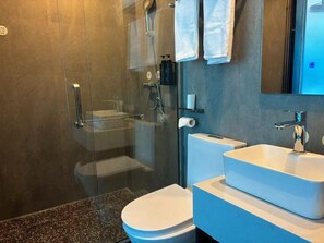 A modern bathroom with a glass-enclosed shower, a toilet, and a sink with a mirror above. - Mcsrh Hotel -Shenzhen Bao'an  (Shenzhen)