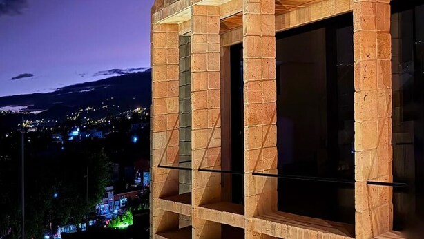 A modern building with a brick facade and large windows. - Cozy, centricand styled 2-bedroom apartment in enchanting Cuenca (Cuenca)