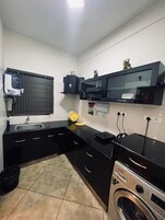 Economy Room, 4 Bedrooms | Private kitchen | Fridge, cookware/dishes/utensils