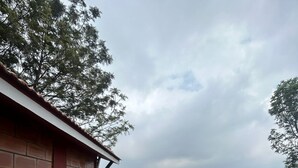A balcony with a view of a hilly landscape. - S ELLA Residency (Kotagiri)