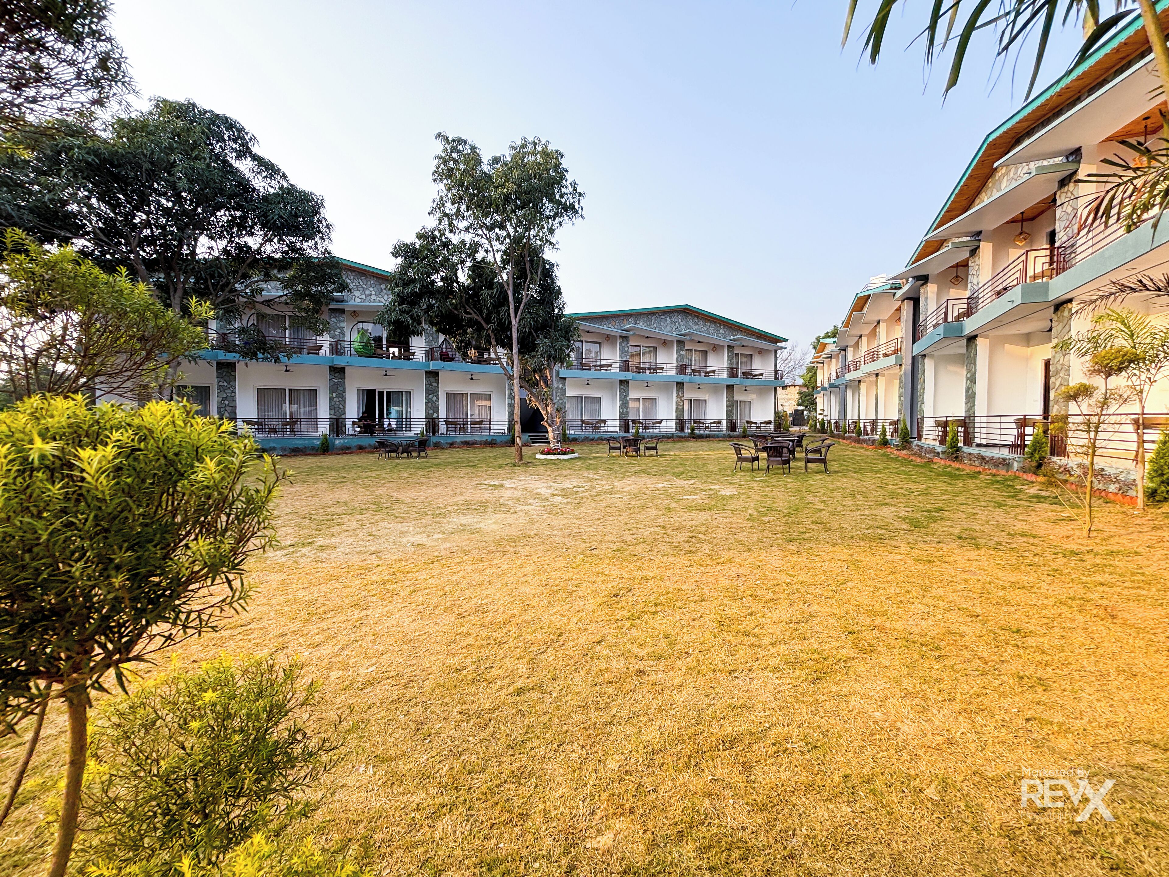 A courtyard with outdoor seating and a building with multiple balconies.