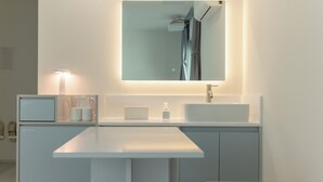 A modern bathroom with a white sink, a mirror, and a built-in shower. - Anook Air Hotel Gaebong (Seoul)