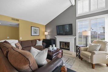 Living Room with Fireplace and Louvered Shutters