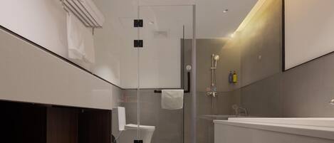A modern bathroom with a glass-enclosed shower, a white bathtub, and a wooden vanity.