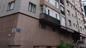 A multi-story residential building with balconies, numbered units, and a visible entrance. - Guest House Ulaanbaatar (Ulaanbaatar)