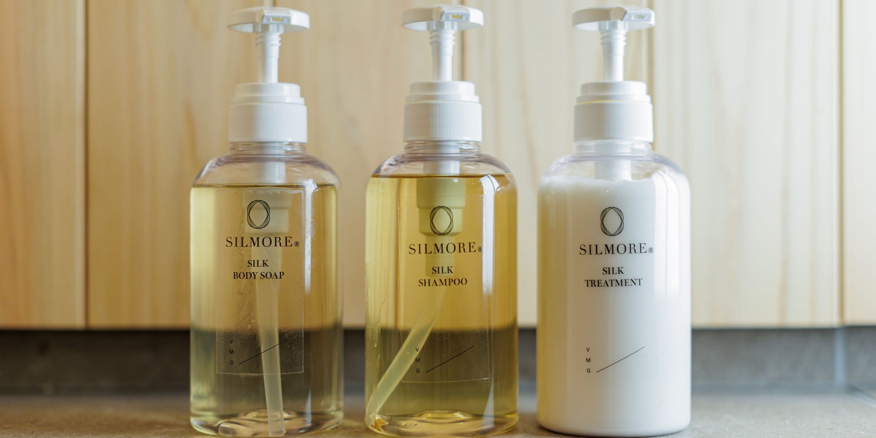 Three bottles of SILMORE products on a countertop.