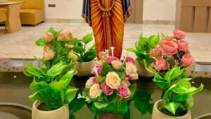 A statue of a deity with a flute, surrounded by potted plants. - Avadh Sunshine Palace Hotel & Resort (Tarabganj)