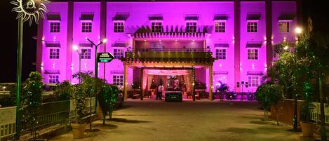A building with a sign reading 'Sunshine Palace' and a sign for 'Avadh Sunshine Restaurant' in front.