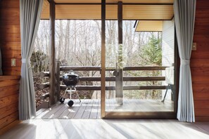 Enjoy a rustic retreat with a balcony offering a forest view, barbecue grill, and cozy interior.