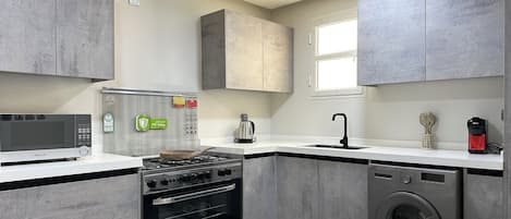 Fridge, microwave, stovetop, coffee/tea maker