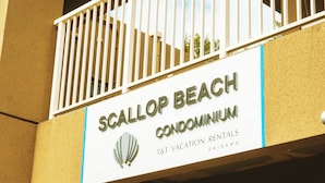 A sign for Scallop Beach Condominium, indicating it offers 1st vacation rentals in Okinawa. - SCALLOP BEACH CONDMINIUM (Onna)
