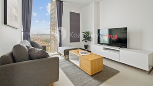 A modern living room with a sofa, coffee table, and TV.