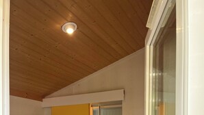 A bedroom with a bed, a yellow door, and a sliding glass door. - Chalet/Spa and private lake (CHALABRE)