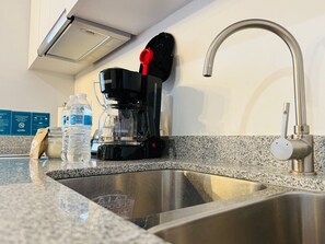 Fridge, oven, coffee/tea maker, cookware/dishes/utensils