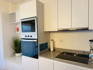 Fridge, oven, coffee/tea maker, cookware/dishes/utensils