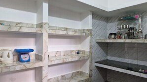A bathroom with marble shelves, a scale, a kettle, and a coffee maker. - Private Flat with open space WiFi and AC in charming Varanasi near Assi Ghat (Varanasi)